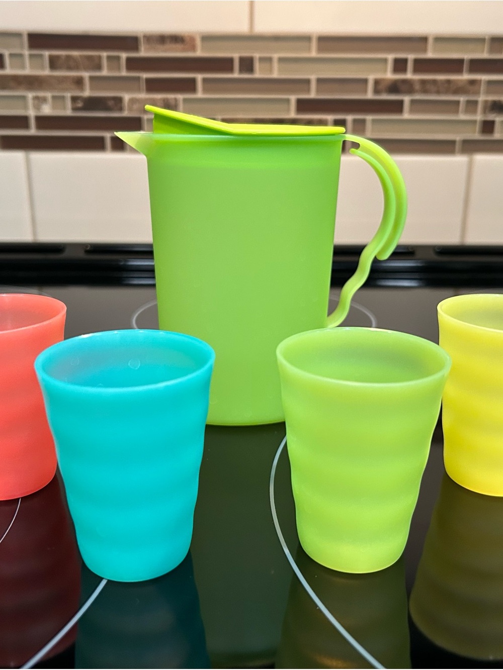 Tupperware Lime Green Pitcher with Turquoise, Coral and Yellow Silicone Cups